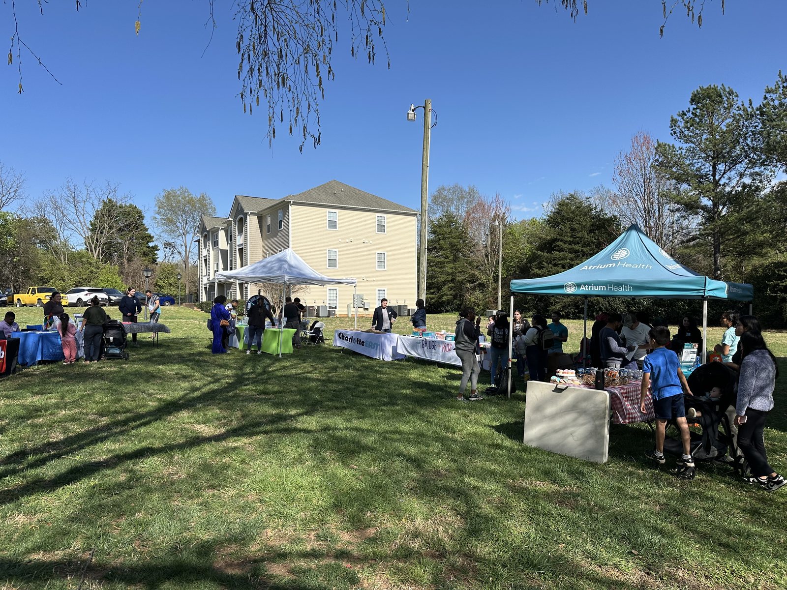 Families meeting local service providers at a Rosecroft community resource fair, including an Atrium Health tent